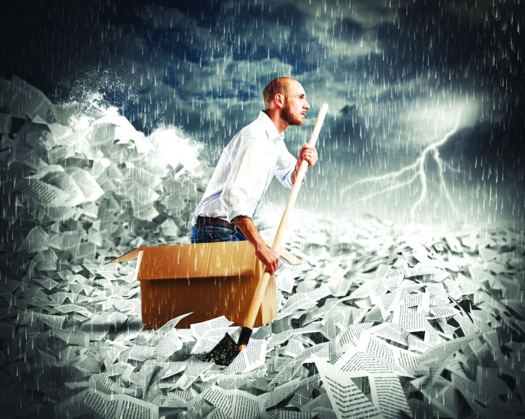 45734323 - concept of bureaucracy with man paddling in a sea of sheets